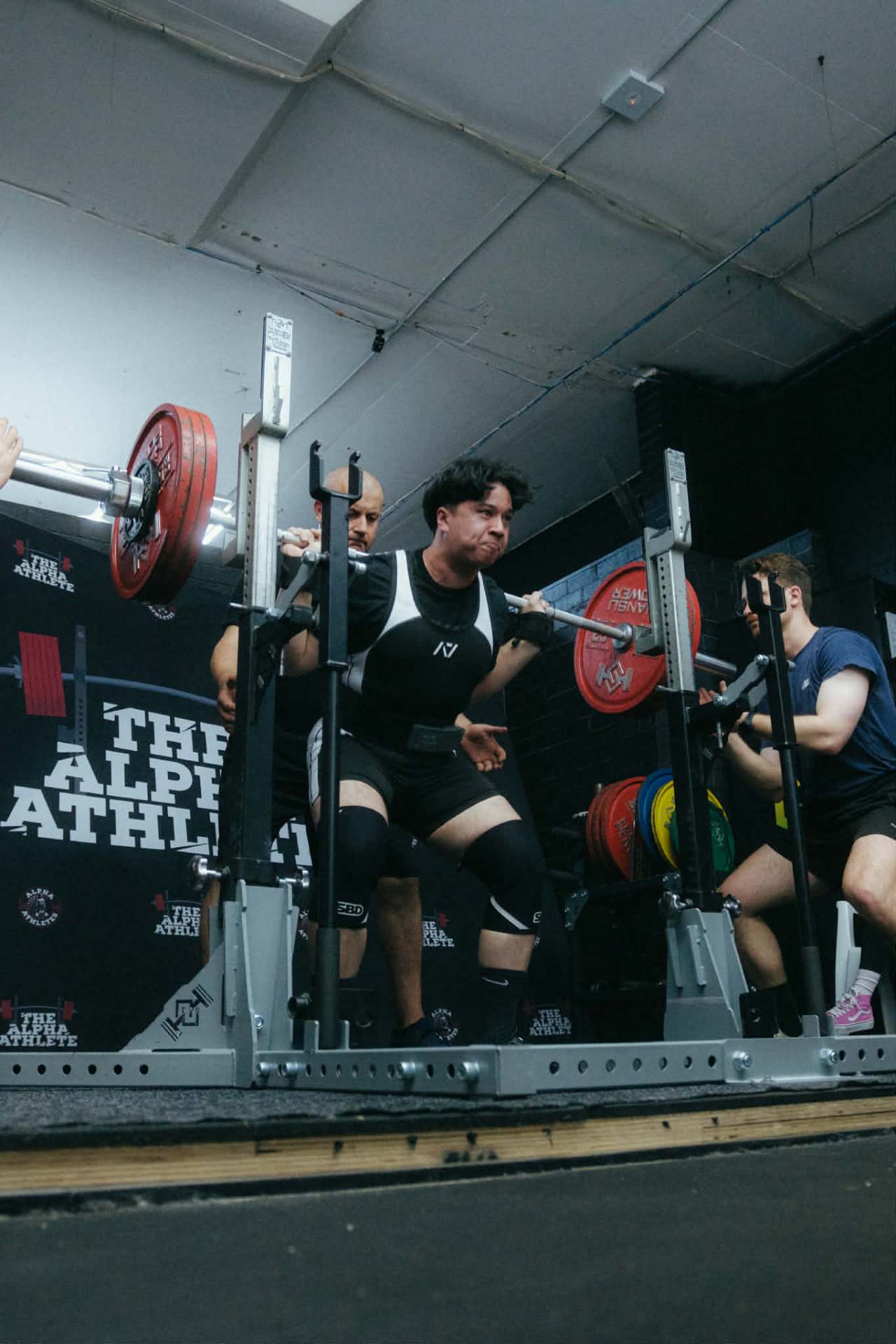 Team member squatting at competition