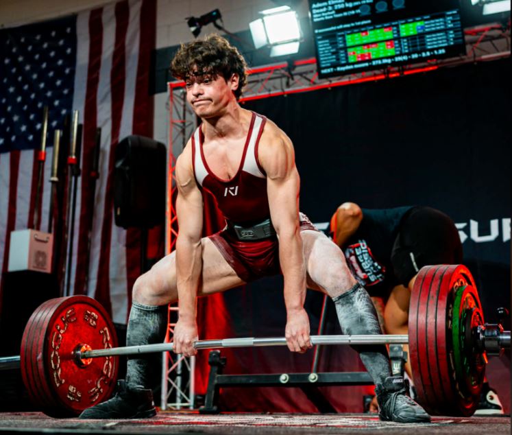 Athlete deadlifting at powerlifting competition